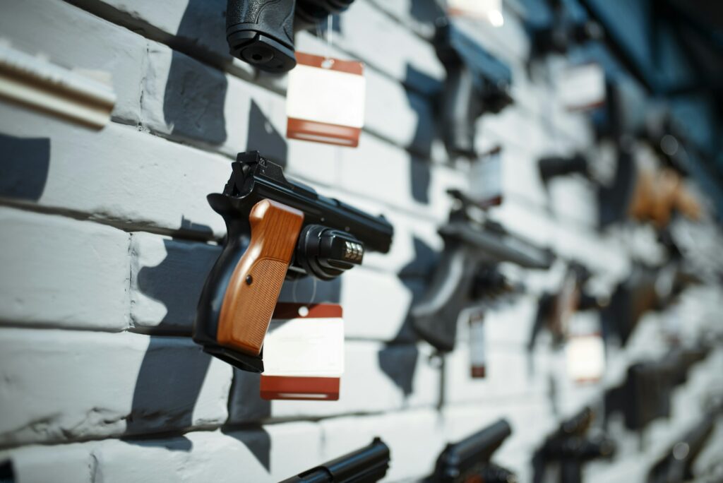 Handguns on showcase in gun shop closeup, nobody
